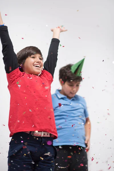 Niños soplando confeti —  Fotos de Stock