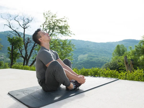 Man doing morning yoga exercises — Stock Photo, Image