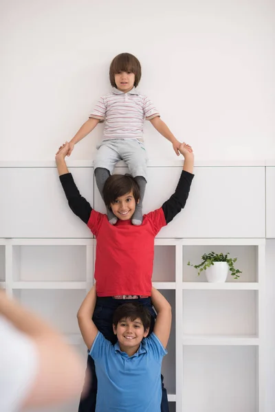 Young boys posing line up piggyback — Stock Photo, Image