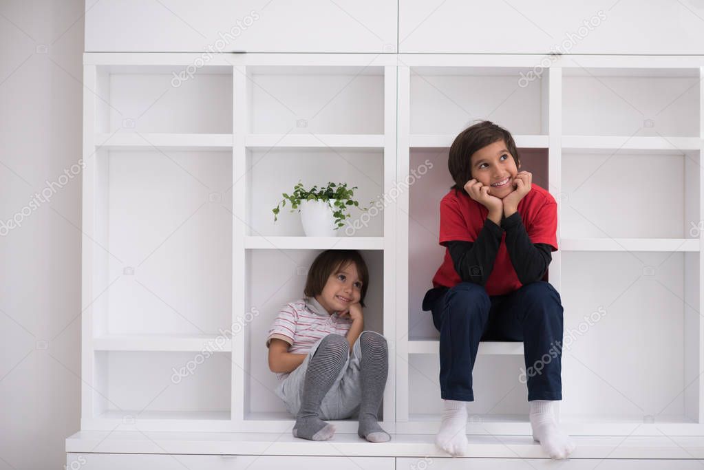 young boys posing on a shelf