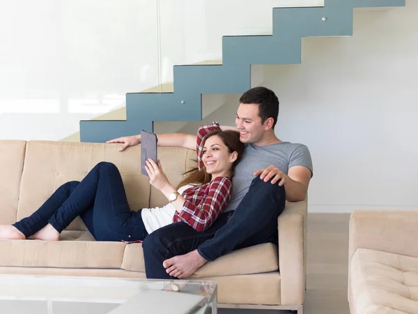 Couple relaxant à la maison avec tablettes — Photo