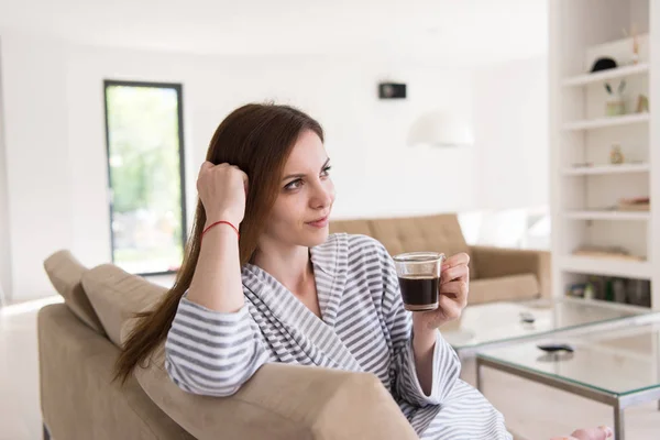 Young woman in a bathrobe enjoying morning coffee — Stock Photo, Image