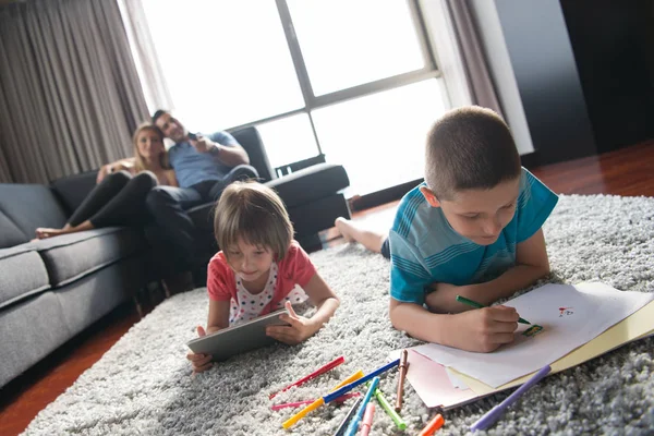 Young couple spending time with kids — Stock Photo, Image