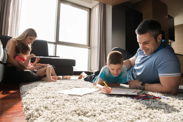 Young couple spending time with kids — Stock Photo, Image