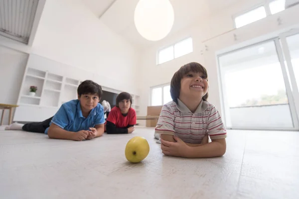 Ragazzi divertirsi con una mela sul pavimento — Foto Stock