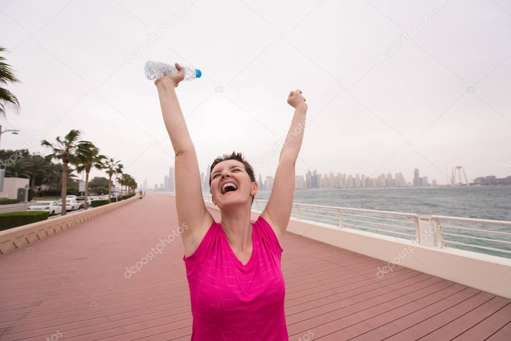 young woman celebrating a successful training run