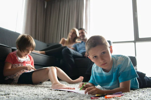 Young couple spending time with kids — Stock Photo, Image