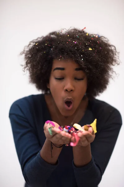 African American woman blowing confetti in the air — Stock Photo, Image
