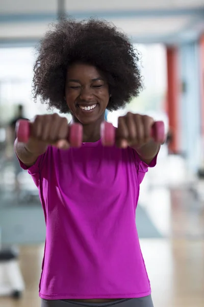 Woman working out in a crossfit gym with dumbbells — Stock Photo, Image