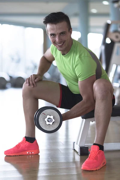 Handsome man working out with dumbbell — Stock Photo, Image