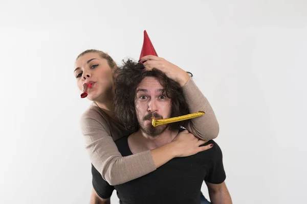 Couple blowing in whistles — Stock Photo, Image