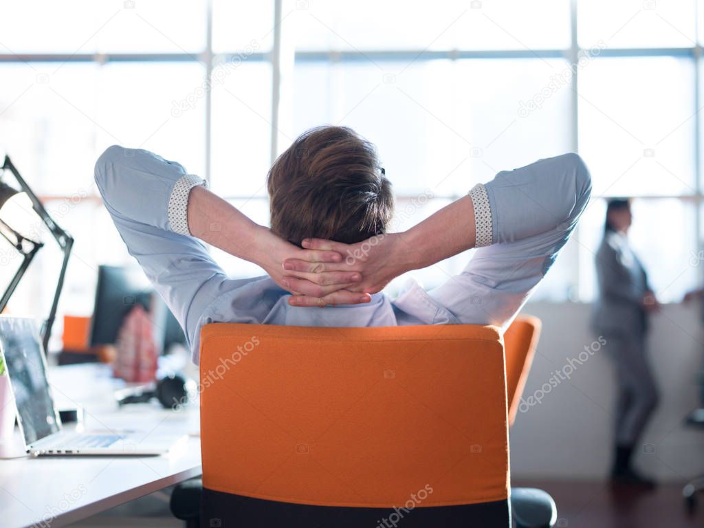 young businessman relaxing at the desk