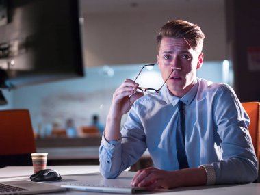 karanlık ofisinde bilgisayarda çalışan adam