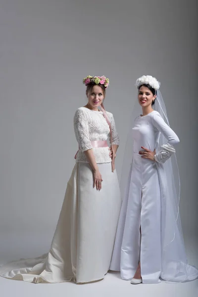 Portrait of two beautiful young brides in wedding dresses — Stock Photo, Image