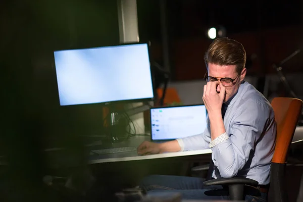 Homme travaillant sur ordinateur dans le bureau sombre — Photo