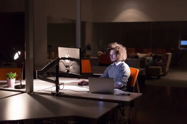 Mężczyzna pracujący na komputerze w biurze ciemny — Zdjęcie stockowe