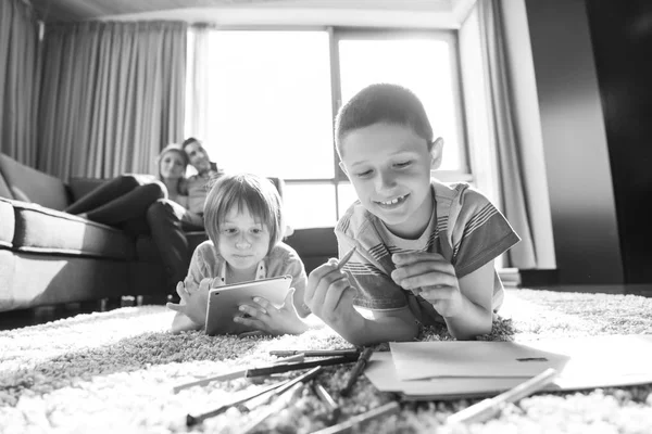 Young couple spending time with kids — Stock Photo, Image