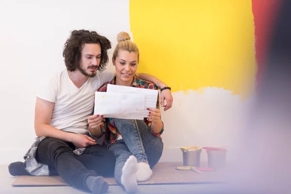 Stock image Happy young couple relaxing after painting