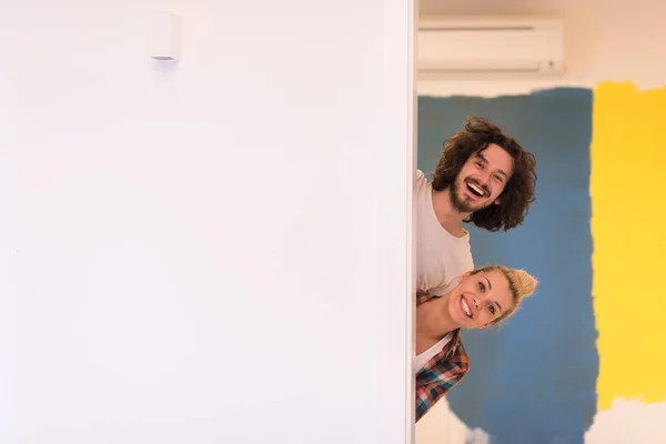 Portrait of a couple painting interior wall — Stock Photo, Image