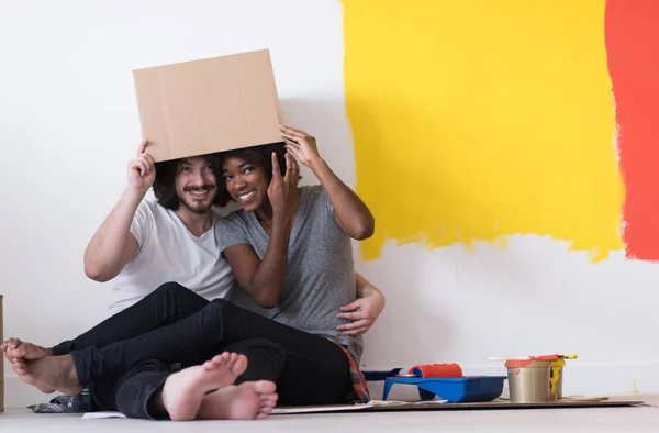 Jovem casal multiétnico brincando com caixas de papelão — Fotografia de Stock