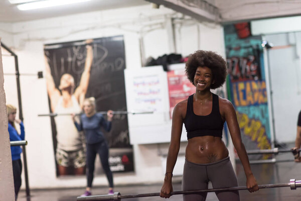 black woman lifting empty bar