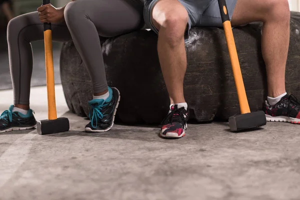 Multiethnic couple after workout with hammer — Stock Photo, Image