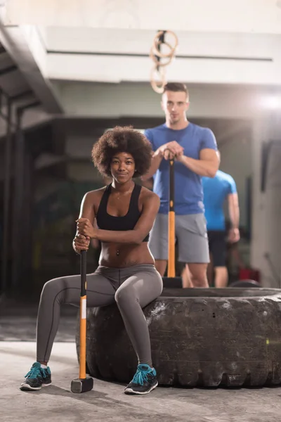 Multiethnic couple after workout with hammer — Stock Photo, Image