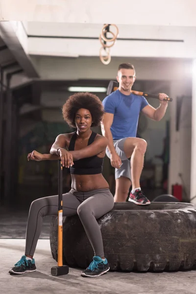 Multiethnic couple after workout with hammer — Stock Photo, Image