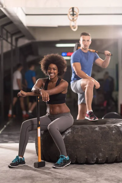 Multiethnic couple after workout with hammer — Stock Photo, Image