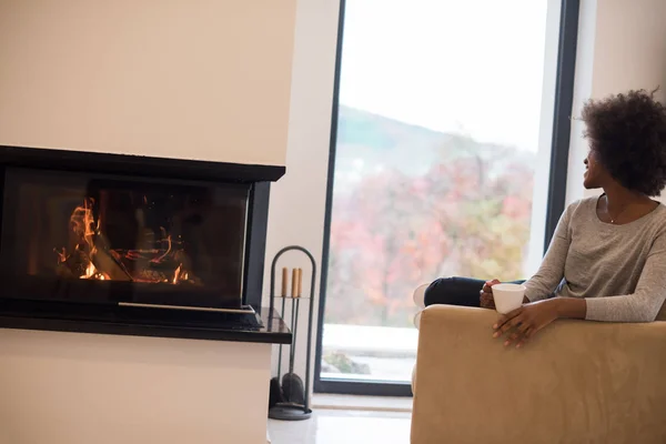 Mujer negra bebiendo café en la chimenea —  Fotos de Stock