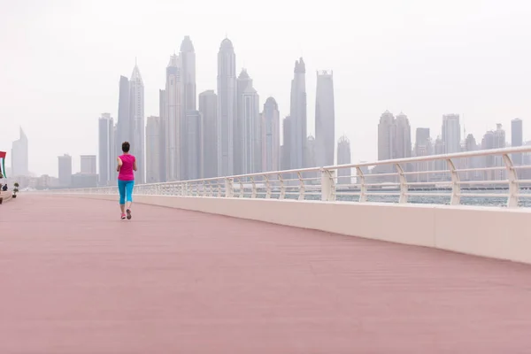 Woman running on the promenade — Stock Photo, Image