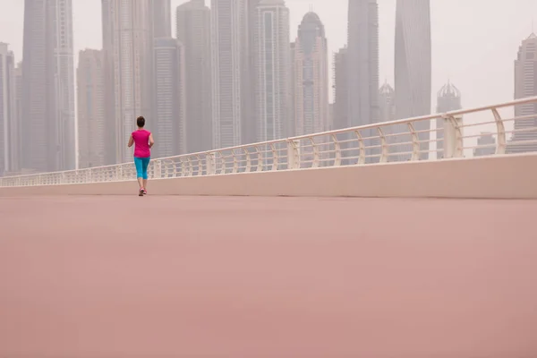 Woman running on the promenade — Stock Photo, Image