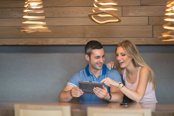 Pareja usando la tableta en casa — Foto de Stock