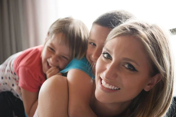 Junge Mutter verbringt Zeit mit Kindern auf dem Fußboden — Stockfoto