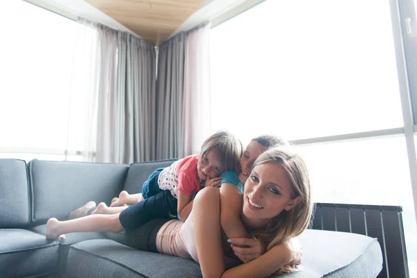 Young mother spending time with kids on the floor — Stock Photo, Image