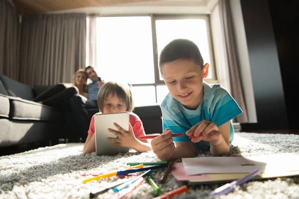 Young couple spending time with kids — Stock Photo, Image