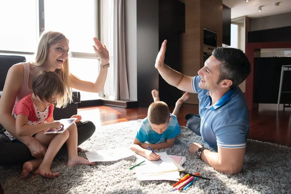Young couple spending time with kids — Stock Photo, Image