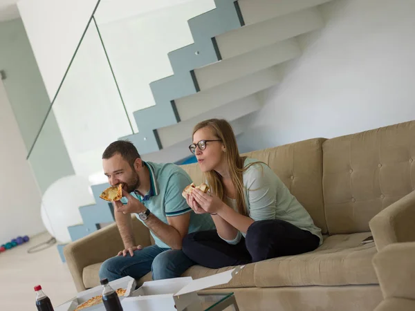 Ζευγάρι, τρώγοντας πίτσα σε τους σπίτι πολυτελείας — Φωτογραφία Αρχείου
