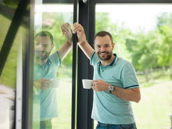 젊은이 창에 의해 마시는 모닝 커피 — 스톡 사진