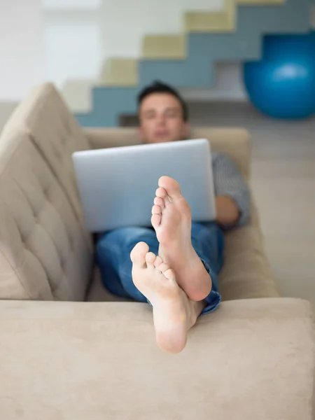 Homem usando laptop na sala de estar — Fotografia de Stock