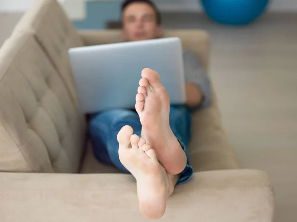 Mann benutzt Laptop im Wohnzimmer — Stockfoto