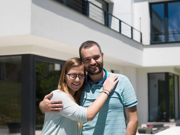 Couple étreignant devant la nouvelle maison de luxe — Photo