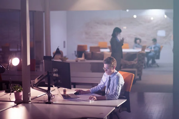 Hombre trabajando en la computadora en la oficina oscura — Foto de Stock