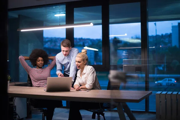 Multiethnic startup business team in night office — Stock Photo, Image