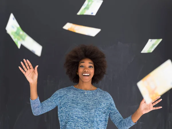 black woman throwing money