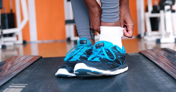 Black female feet in sneakers — Stock Photo, Image