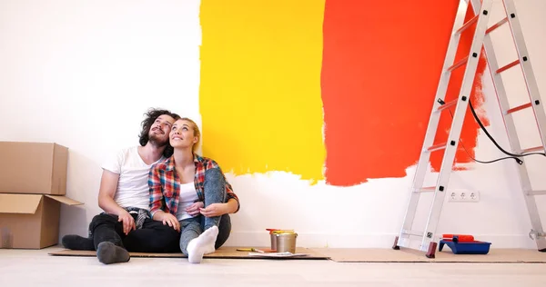 Szczęśliwa Młoda para relaksujący po malowaniu — Zdjęcie stockowe