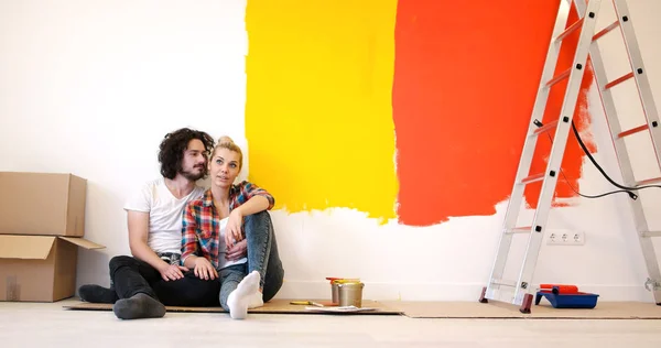 Feliz joven pareja relajándose después de pintar —  Fotos de Stock