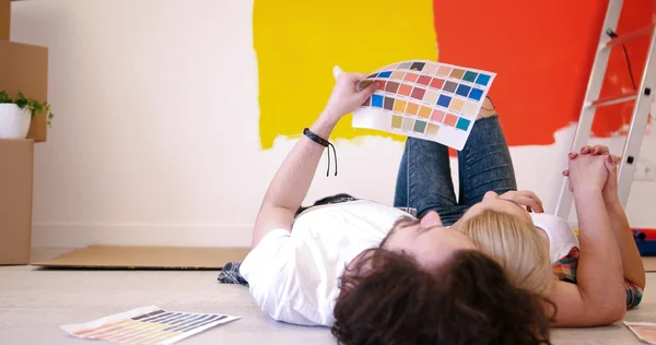 Happy young couple relaxing after painting — Stock Photo, Image