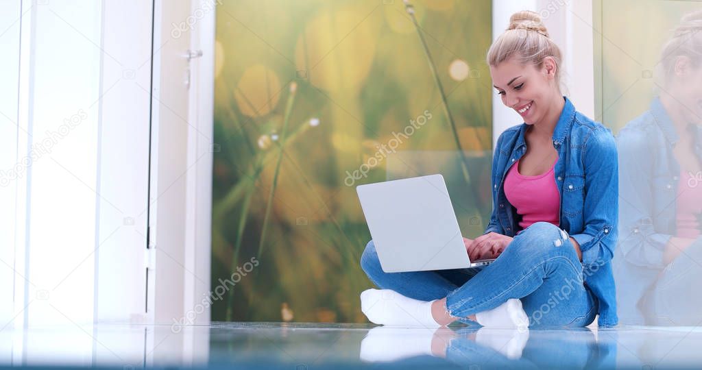 young women using laptop computer on the floor